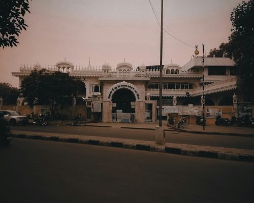 a large white building sitting on the side of a road